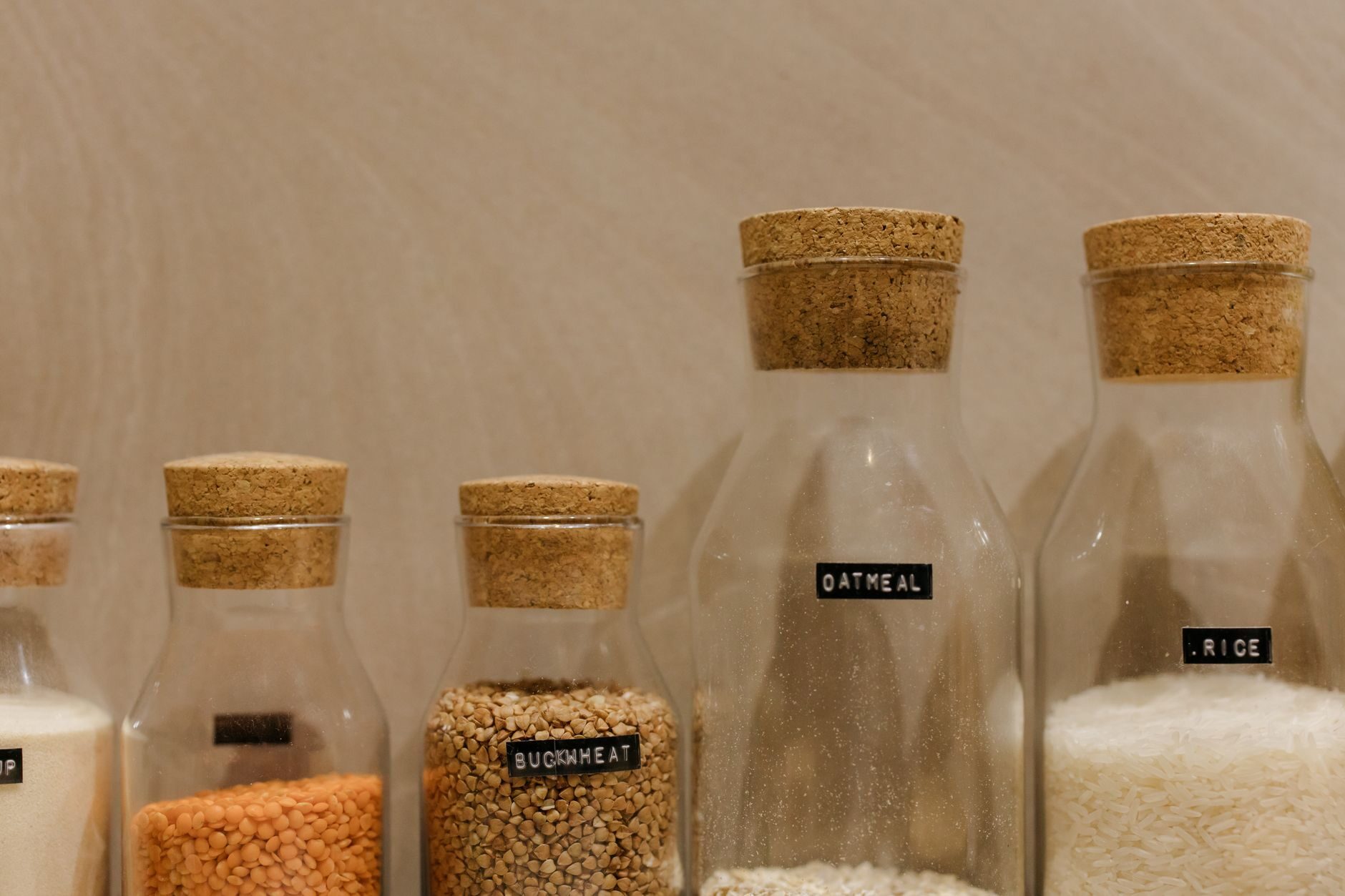Close-up of labelled pantry containers with grains and dry goods